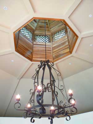 An fine, large chandalier is suspended below the central skylight.